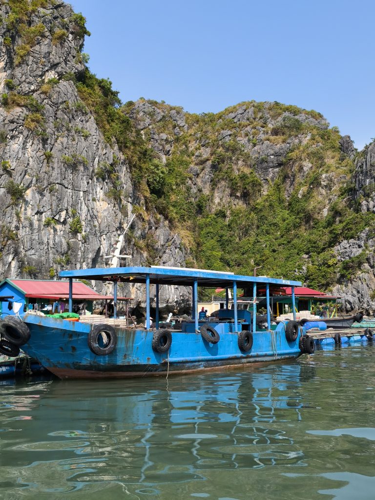 Blaues Hausboot, Felsen im Hintergrund